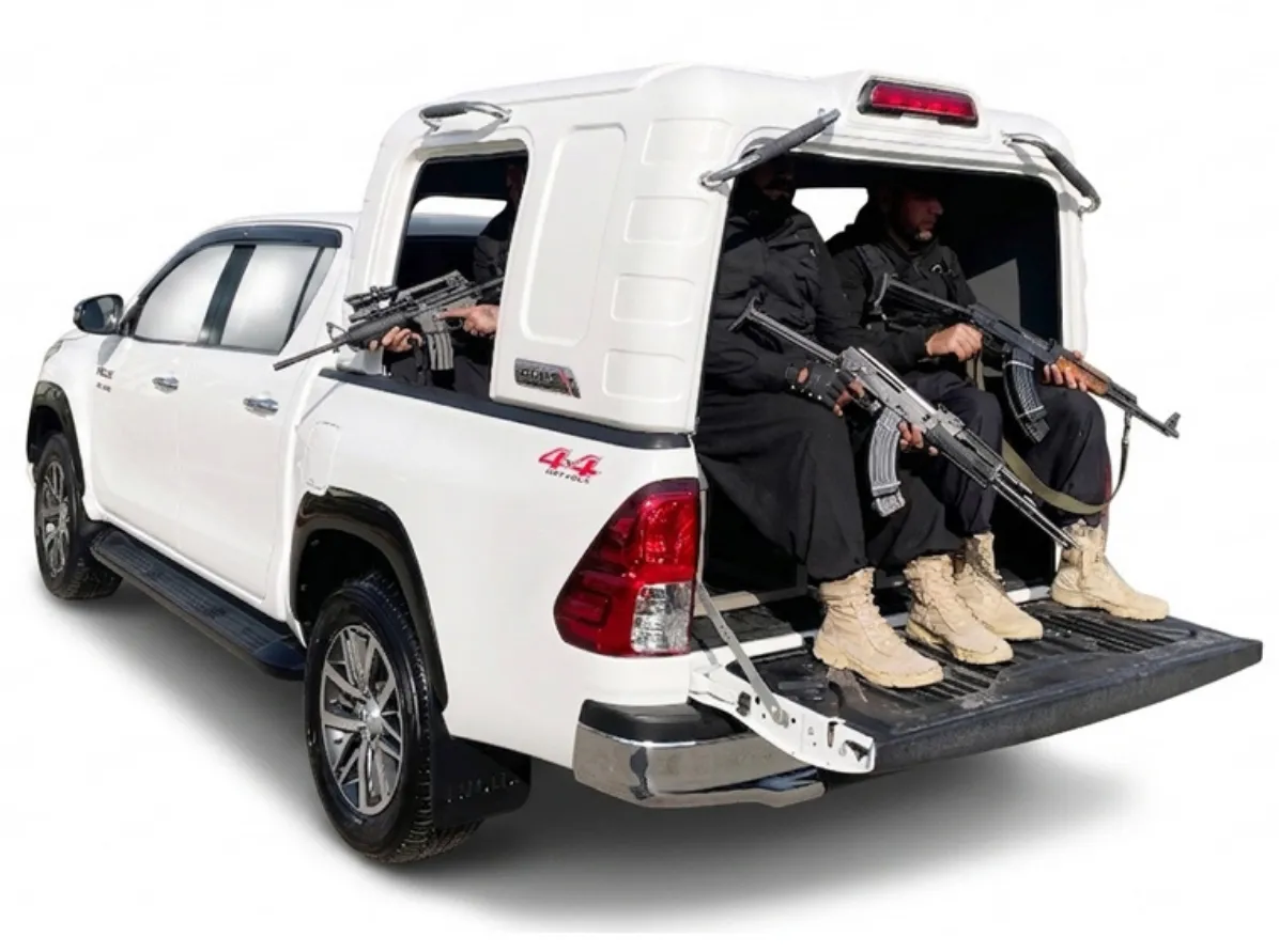 Toyota Hilux Revo with Escort QRF canopy carrying armed guards in rear security